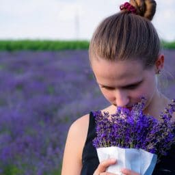 woman smelling a bouquet of lavender