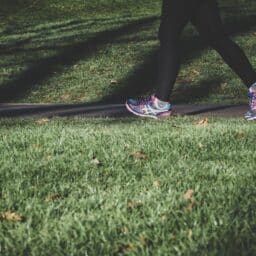 Close-up of woman jogging through a park.