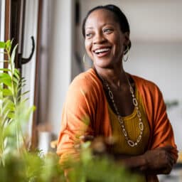 Happy woman looking out the window