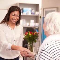 Elderly woman meeting with her audiologist.