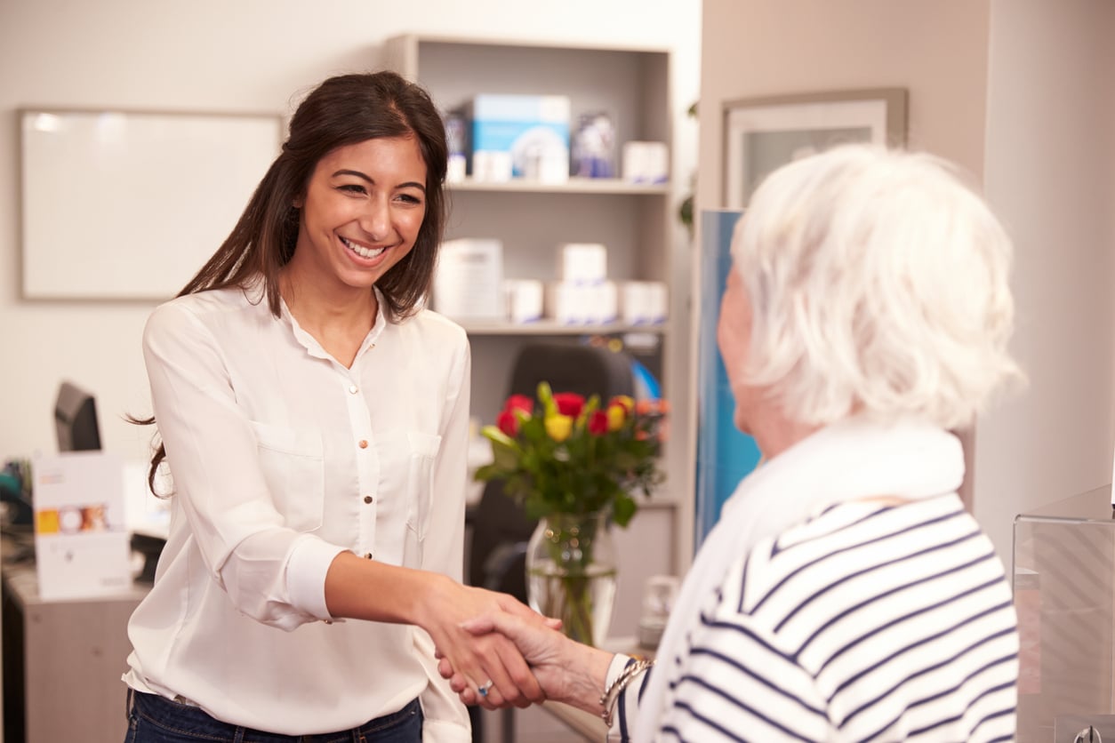 Elderly woman meeting with her audiologist.
