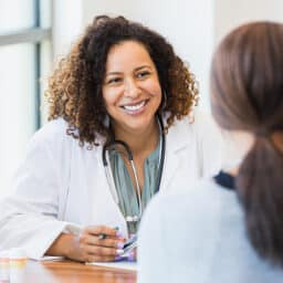 Friendly, professional allergist listening to her patient.