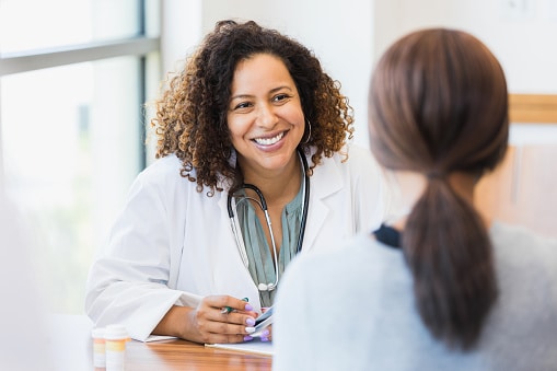 Friendly, professional allergist listening to her patient.