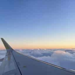 View of the magical clouds at sunset from the airplane window